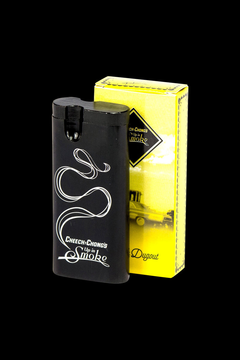 Front three-quarter view of the black Cheech & Chong Dugout - Up in Smoke with white smoke graphics, shown beside its yellow box.