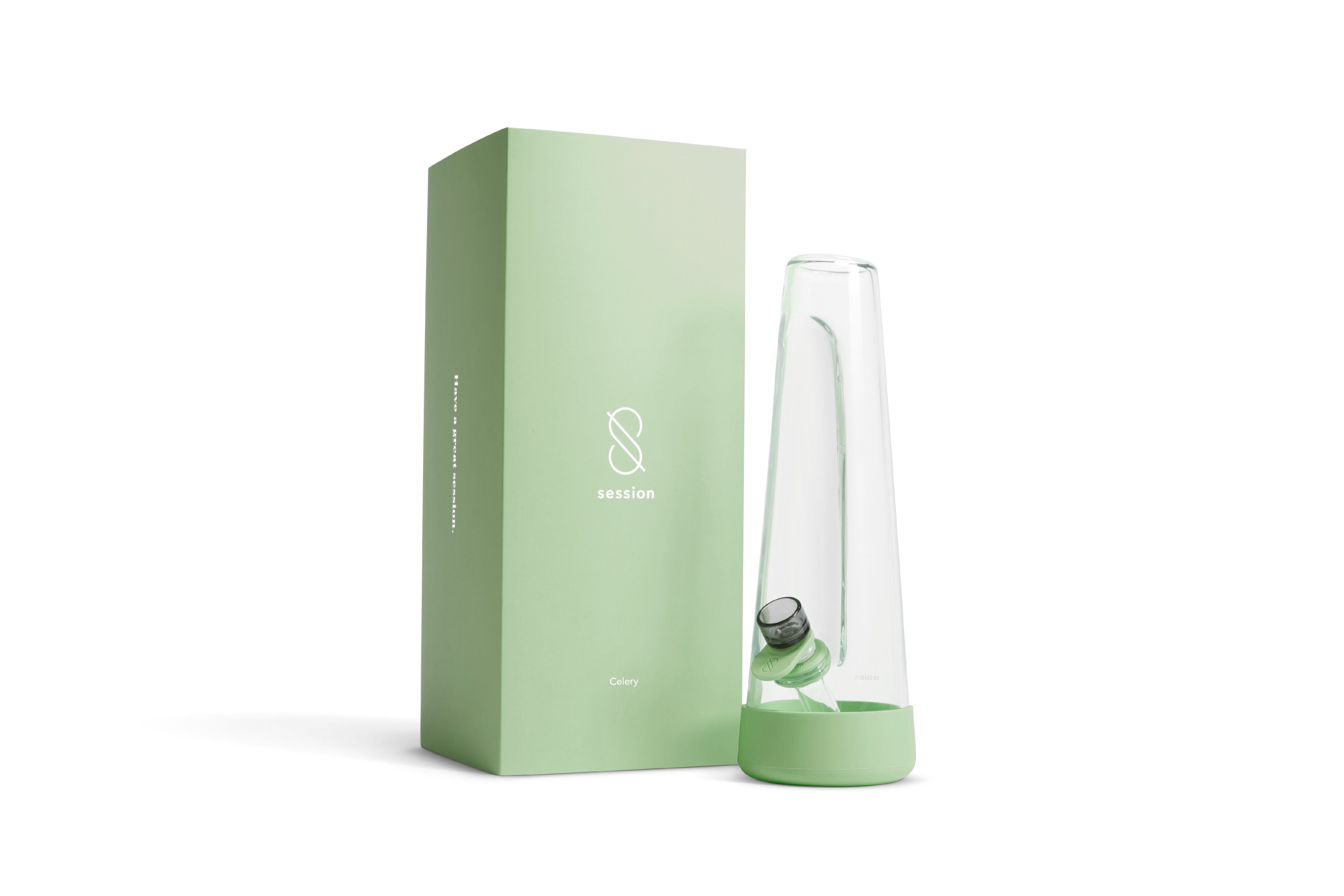 Side view of a clear glass piece beside its pale green box showing the Session Goods Modern Bong with matching green base and bowl.