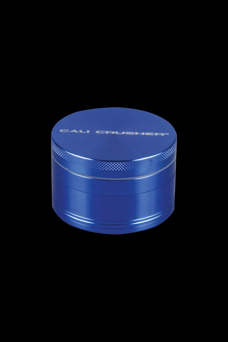 Front view of the Cali Crusher O.G. 2.5" 4 Piece Grinder, a metal grinder with a textured top and a sleek, cylindrical design.