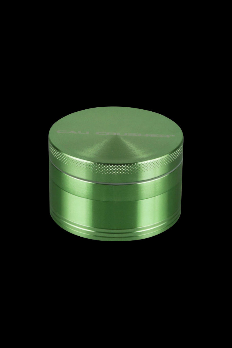 Front view of the Cali Crusher O.G. 2.5" 4 Piece Grinder, a metallic grinder with a textured top and a smooth, cylindrical body.