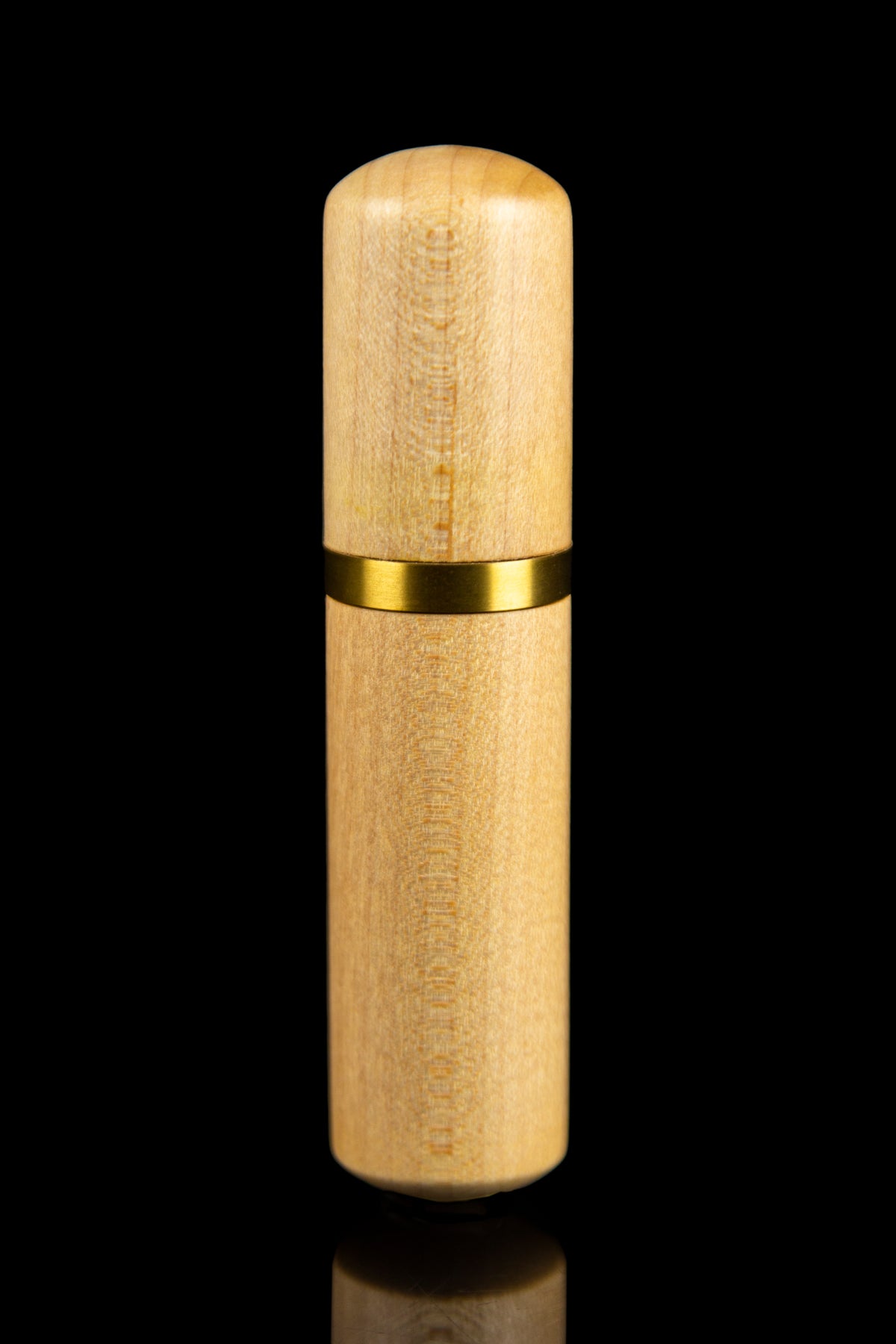Golden cannabis oil vape pen against a black background.