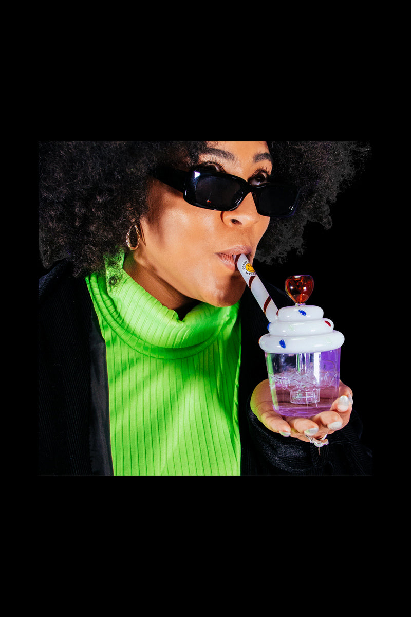 A close-up, front view showcases the Goody Cupcake Bubbler held by a person wearing a green shirt.