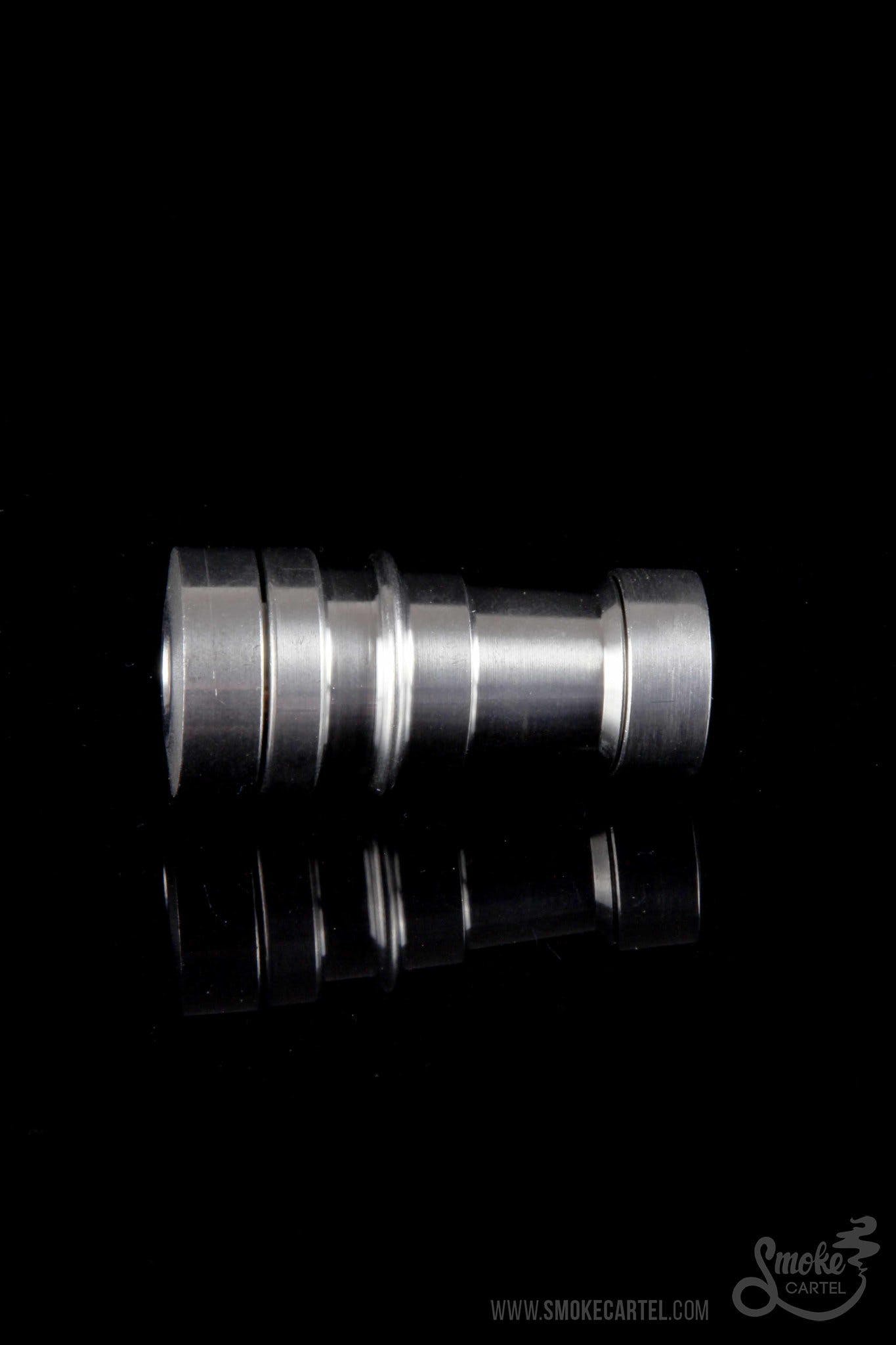 Silver cannabis oil burner with mirrored reflection on black background.