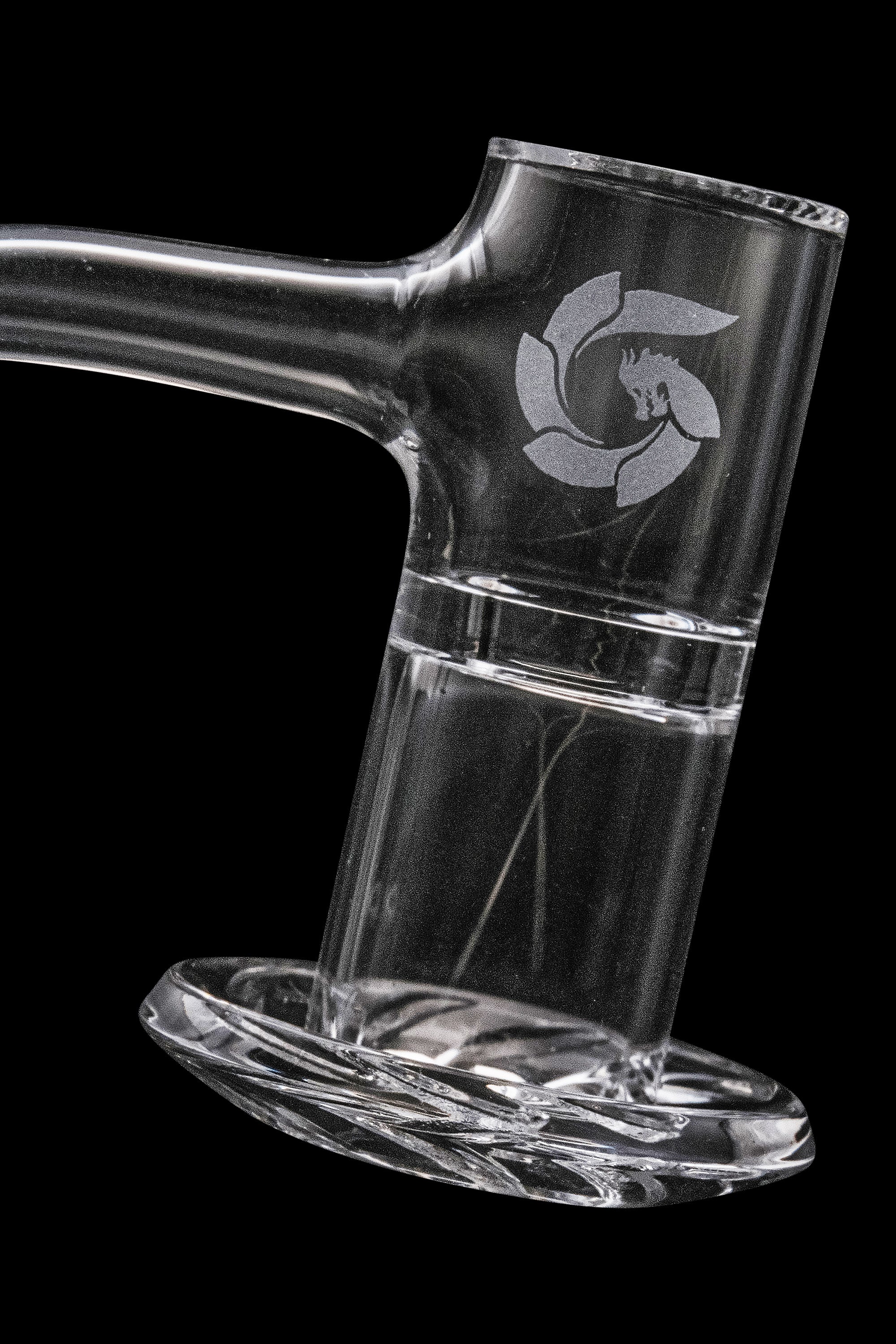 Clear glass dab rig with etched logo, isolated on black.