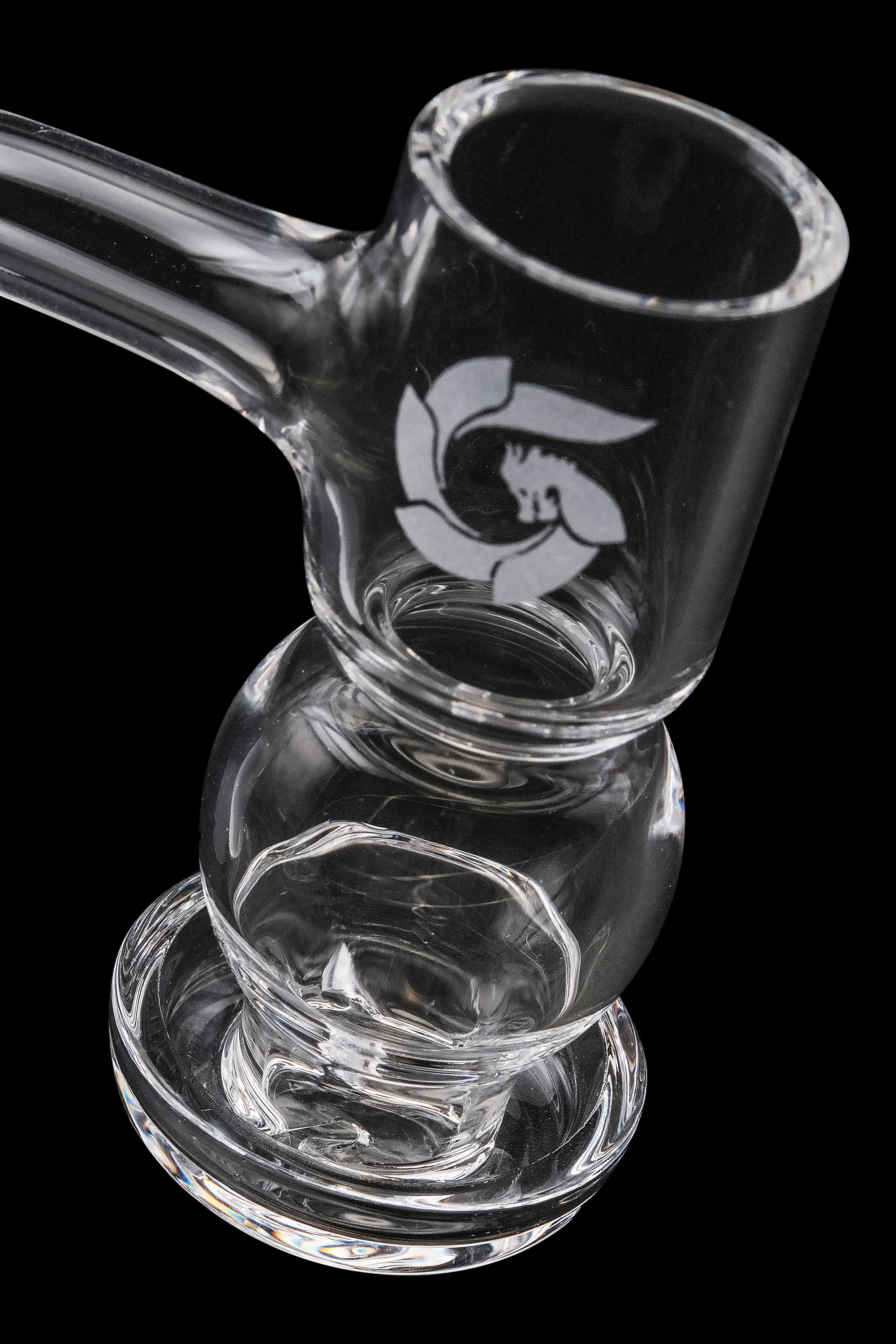 Clear glass bubbler with etched logo, isolated on black.