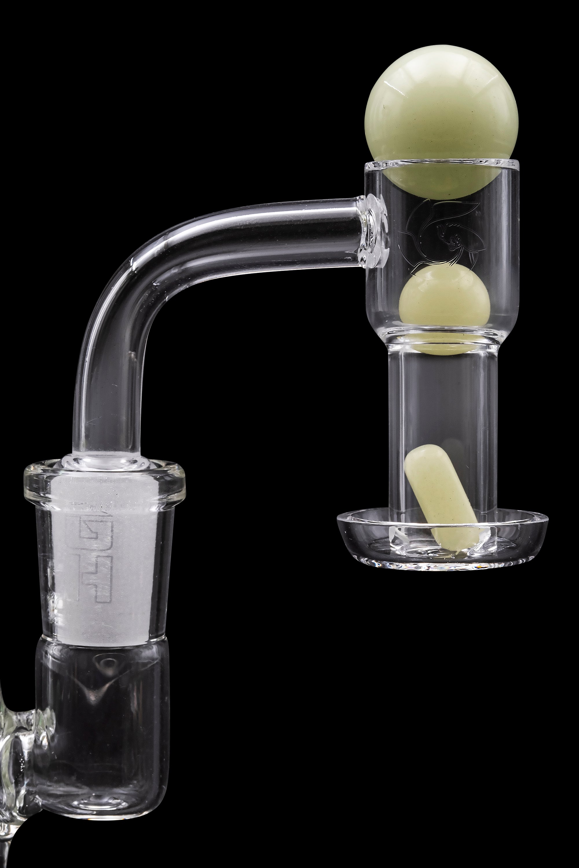 Clear glass dab rig with pale green accents and spherical bubbles, against a black background.