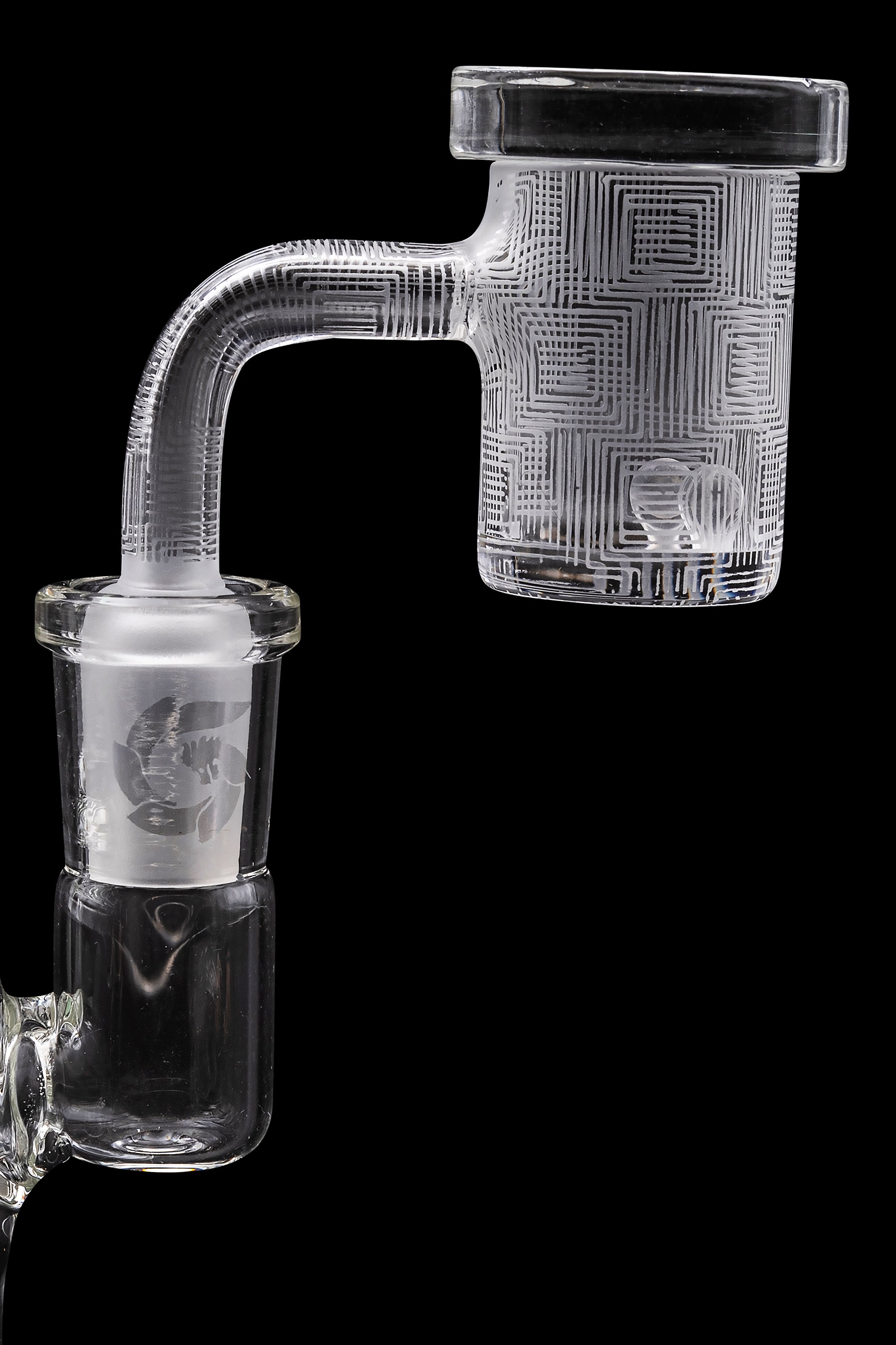 Clear glass cannabis concentrate carb cap with intricate geometric patterns, isolated on a black background.