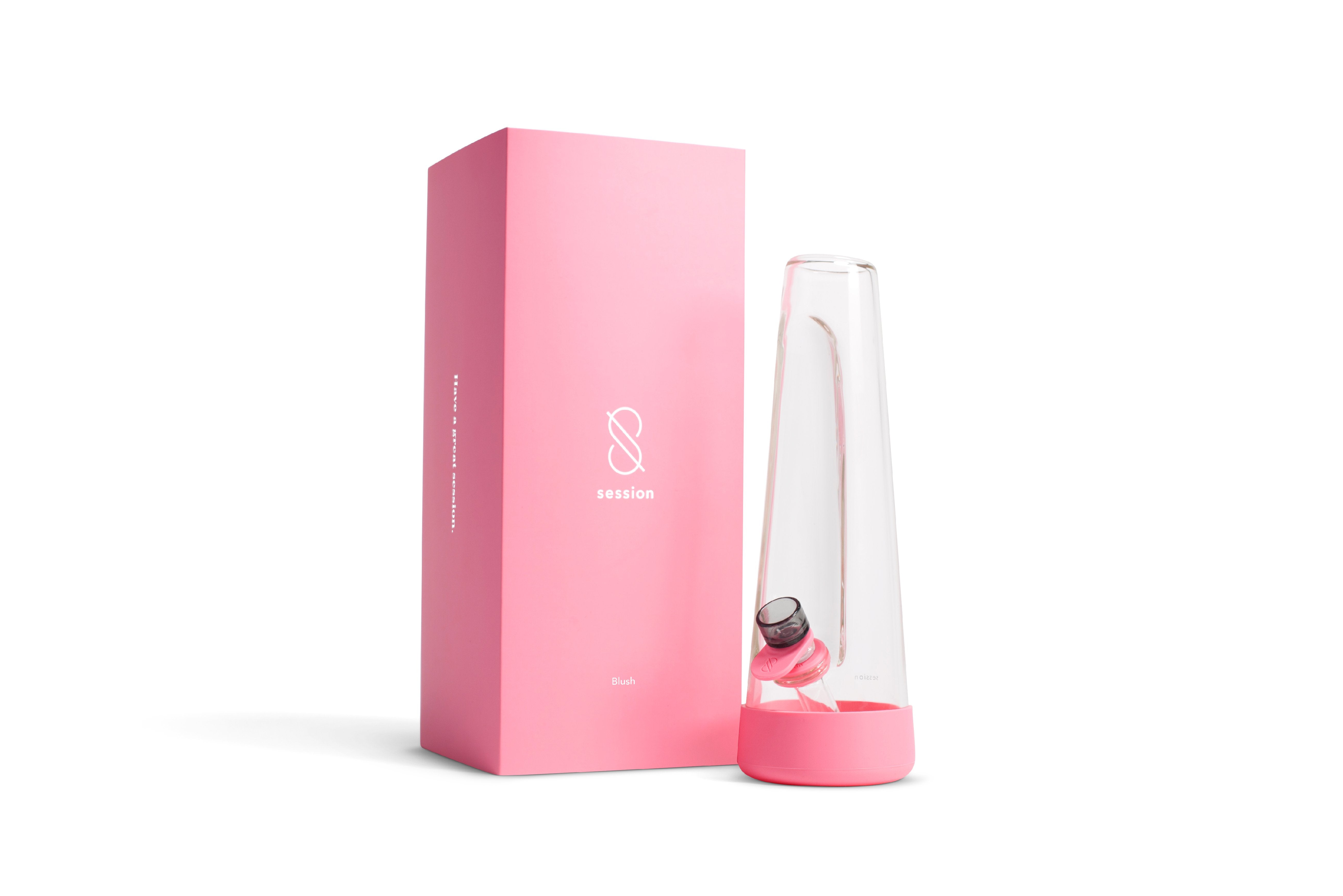 Three-quarter view of the clear glass Session Goods Modern Bong beside its pink branded box on a white background