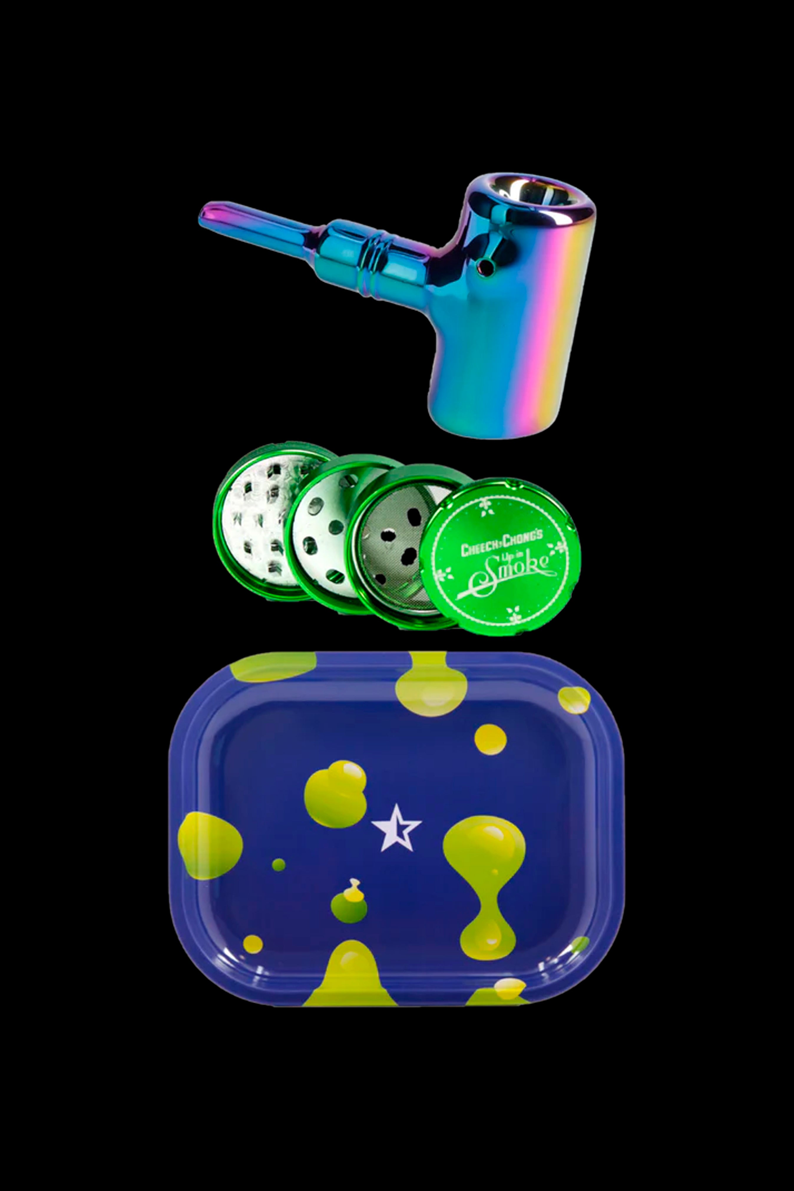 Iridescent glass pipe, metal grinder, and patterned rolling tray on a black background.