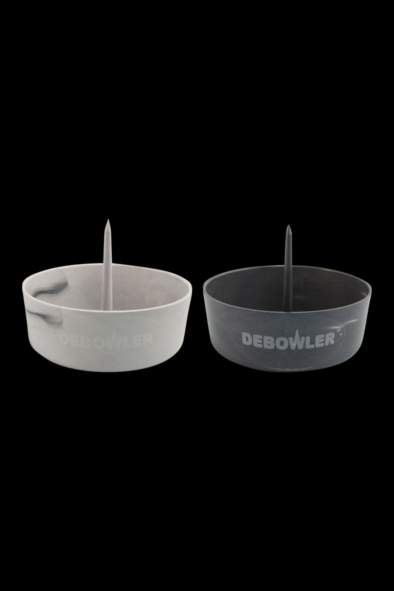 Front-on view of two Debowler Ashtray bowls in black and gray with central spikes and the DEBOWLER logo visible on the side.
