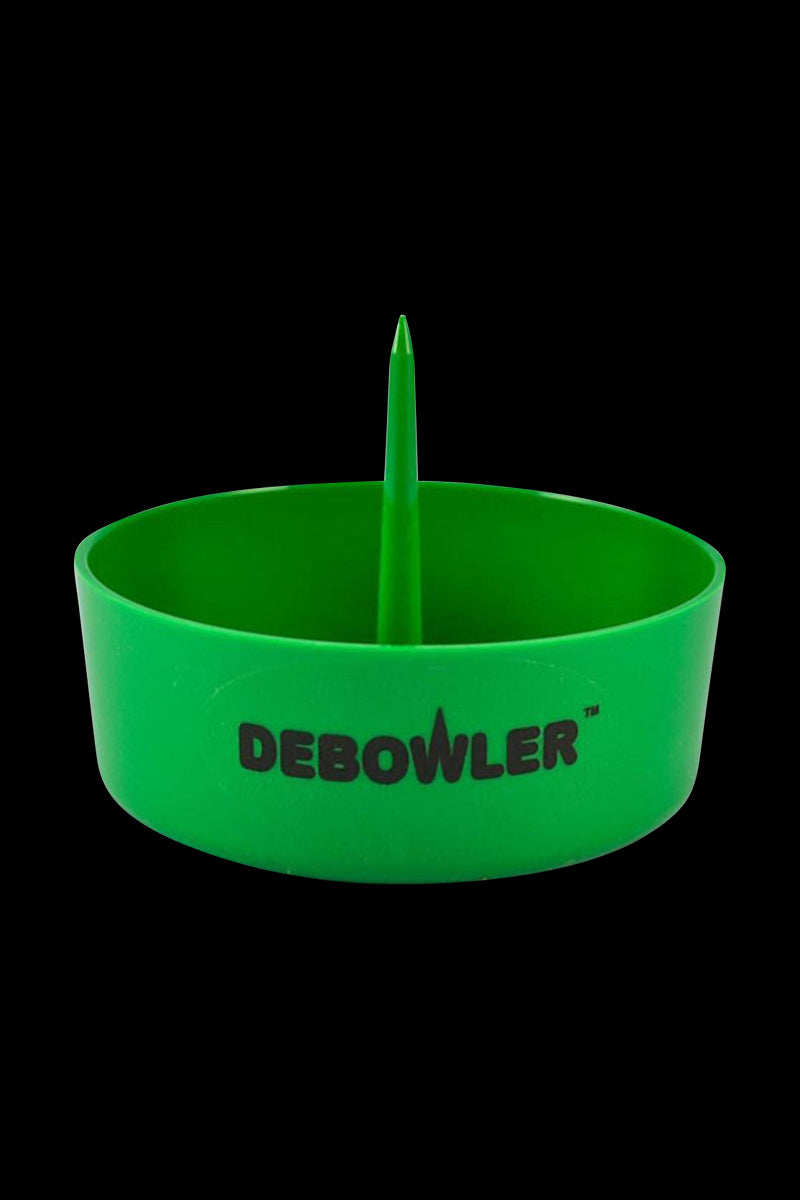 Front-facing shot of the green Debowler Ashtray with its central spike and logo visible against a black background