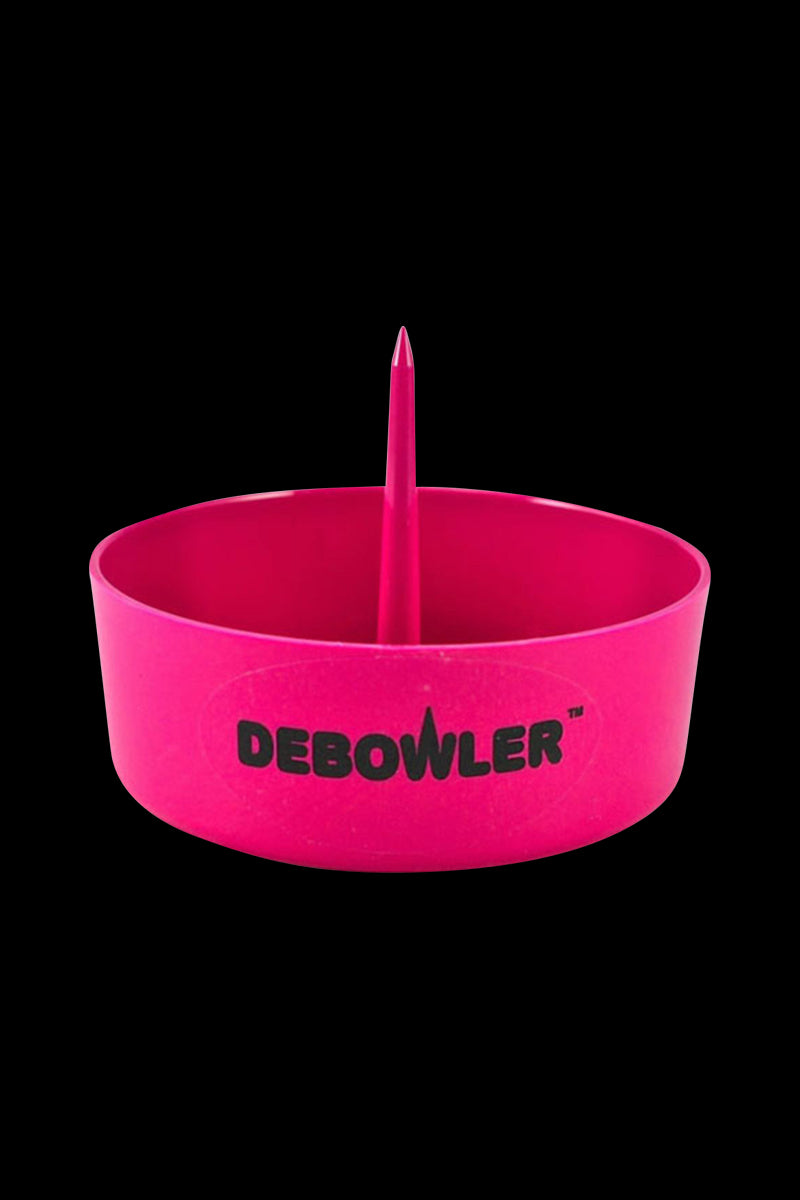 Front-facing shot of the pink Debowler Ashtray bowl with a central upright spike and bold logo on a black background