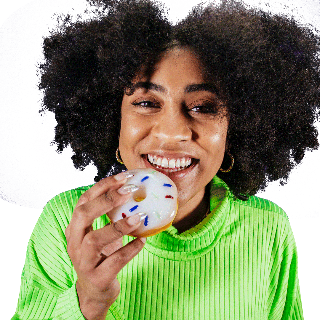 A close-up, front view of the Goody Donut Hand Pipe held by a person with a bright smile.