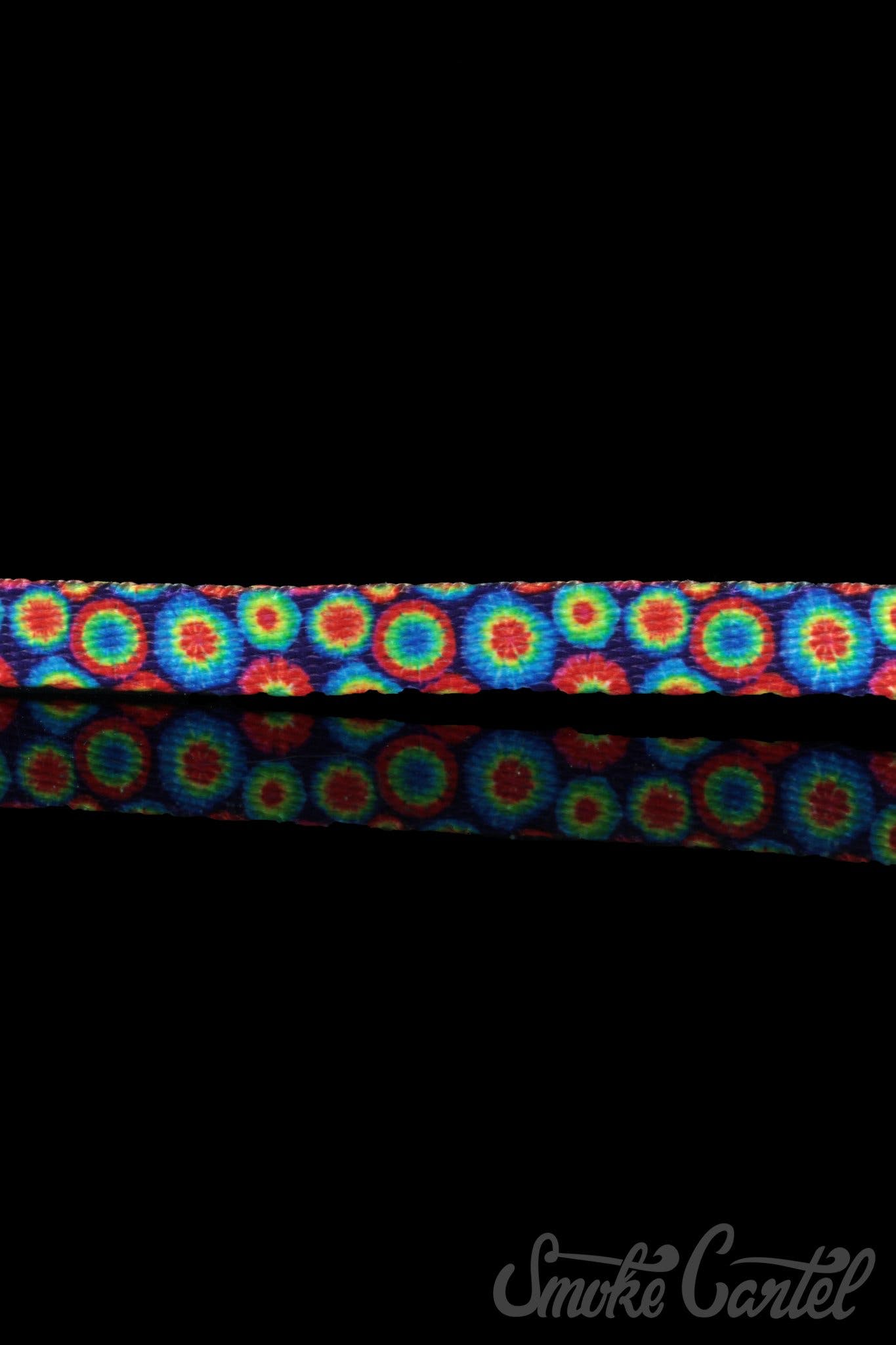 Overhead shot of the HeadyPet Cat Collar, featuring a colorful, patterned design against a dark background.