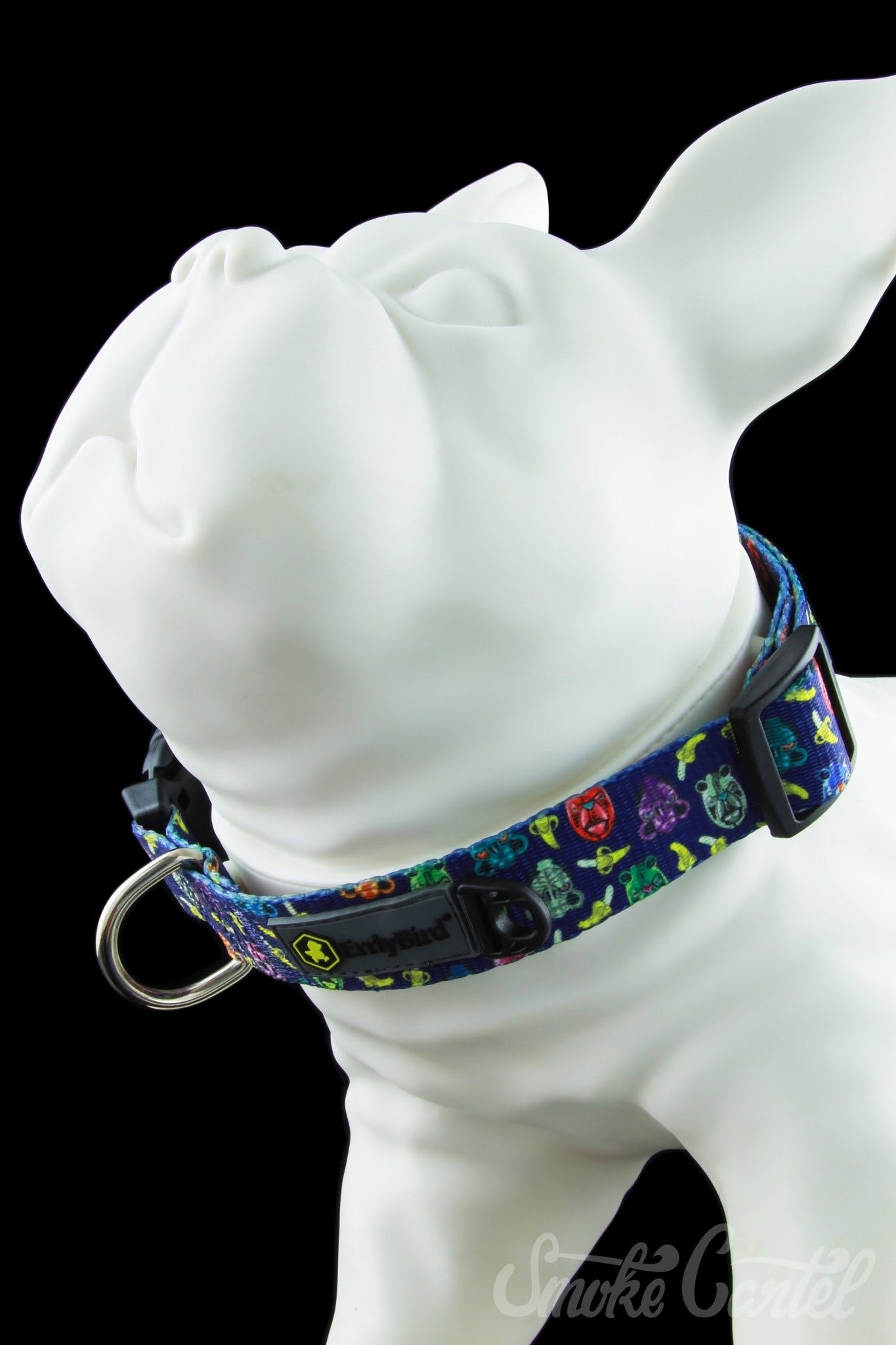 A close-up, angled shot of the HeadyPet OG Collar, featuring a colorful patterned fabric design and silver buckle hardware.