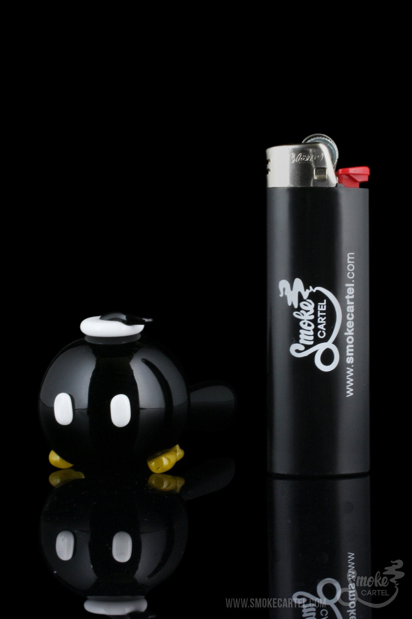 The Empire Glassworks Time Bomb Spoon, a clear glass piece, is displayed in a dynamic angled shot.