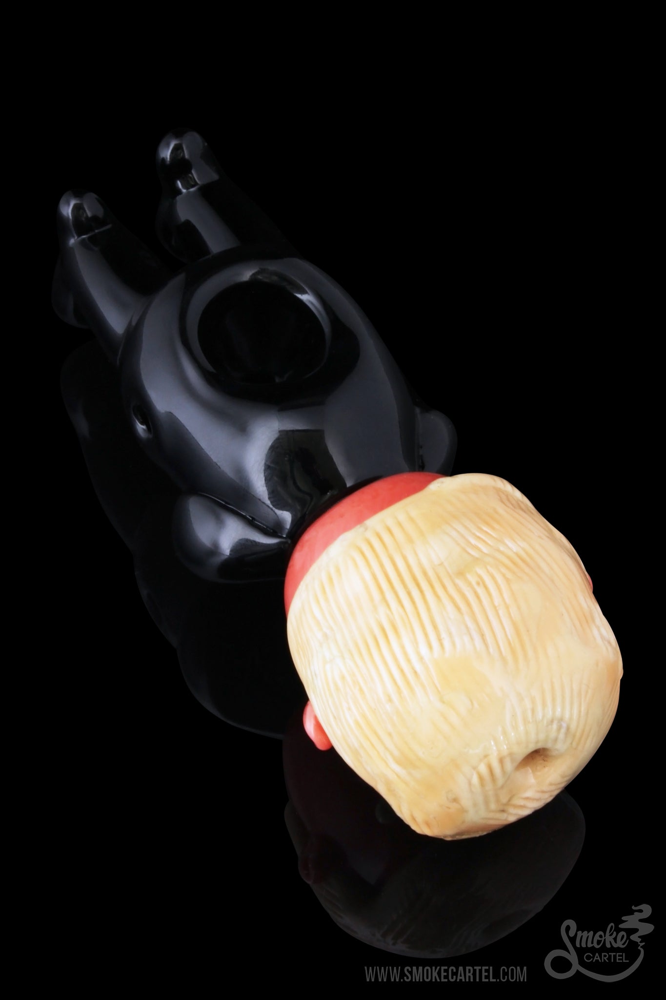 Black glass water pipe with a peach-colored mouthpiece resting on a black surface.