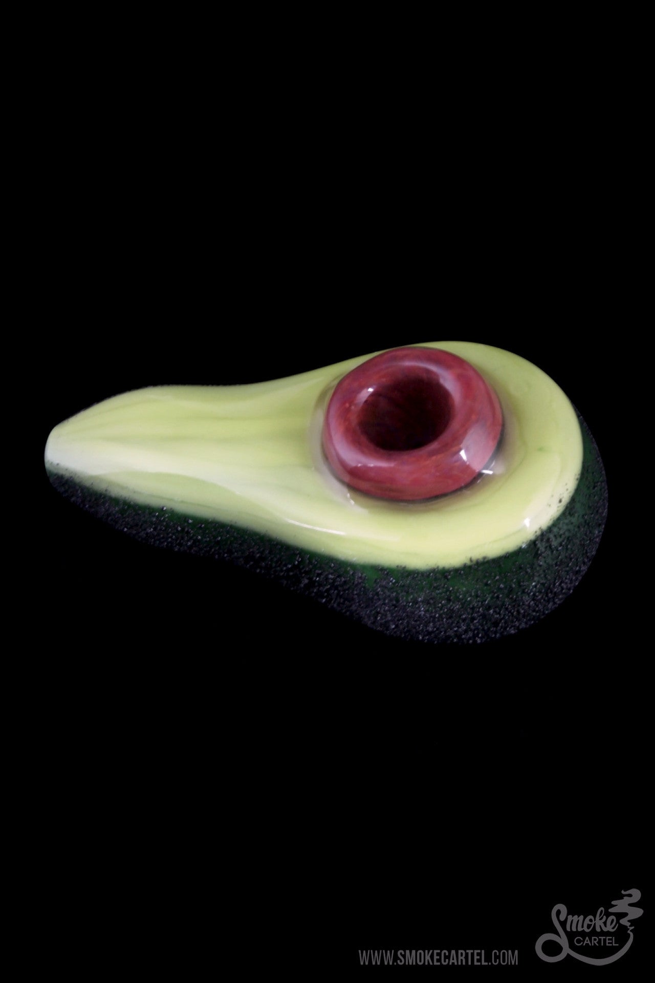 A close-up shot of the Empire Glassworks "Avocadope" hand pipe, sculpted like an avocado with a green finish.