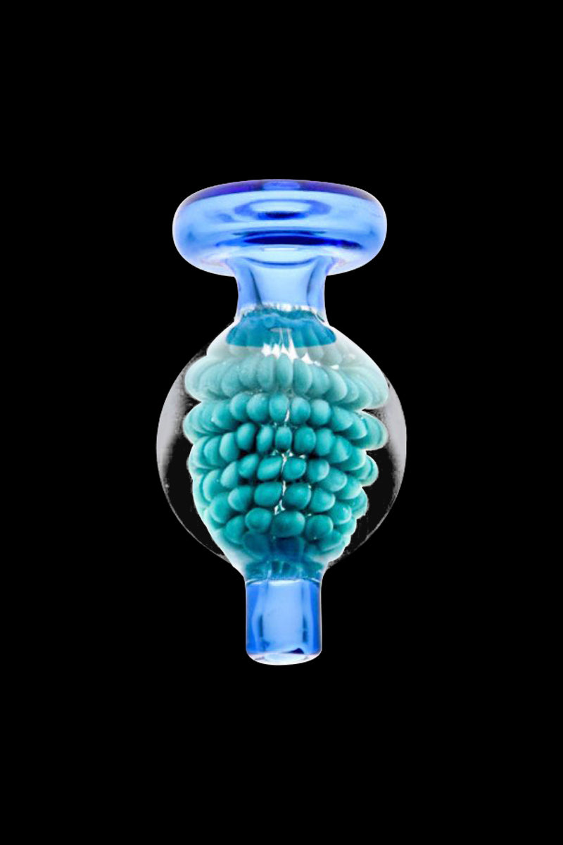 A close-up angled view of the Encased Blackberry Pattern Bubble Carb Cap, showing a patterned glass dome against a dark background.