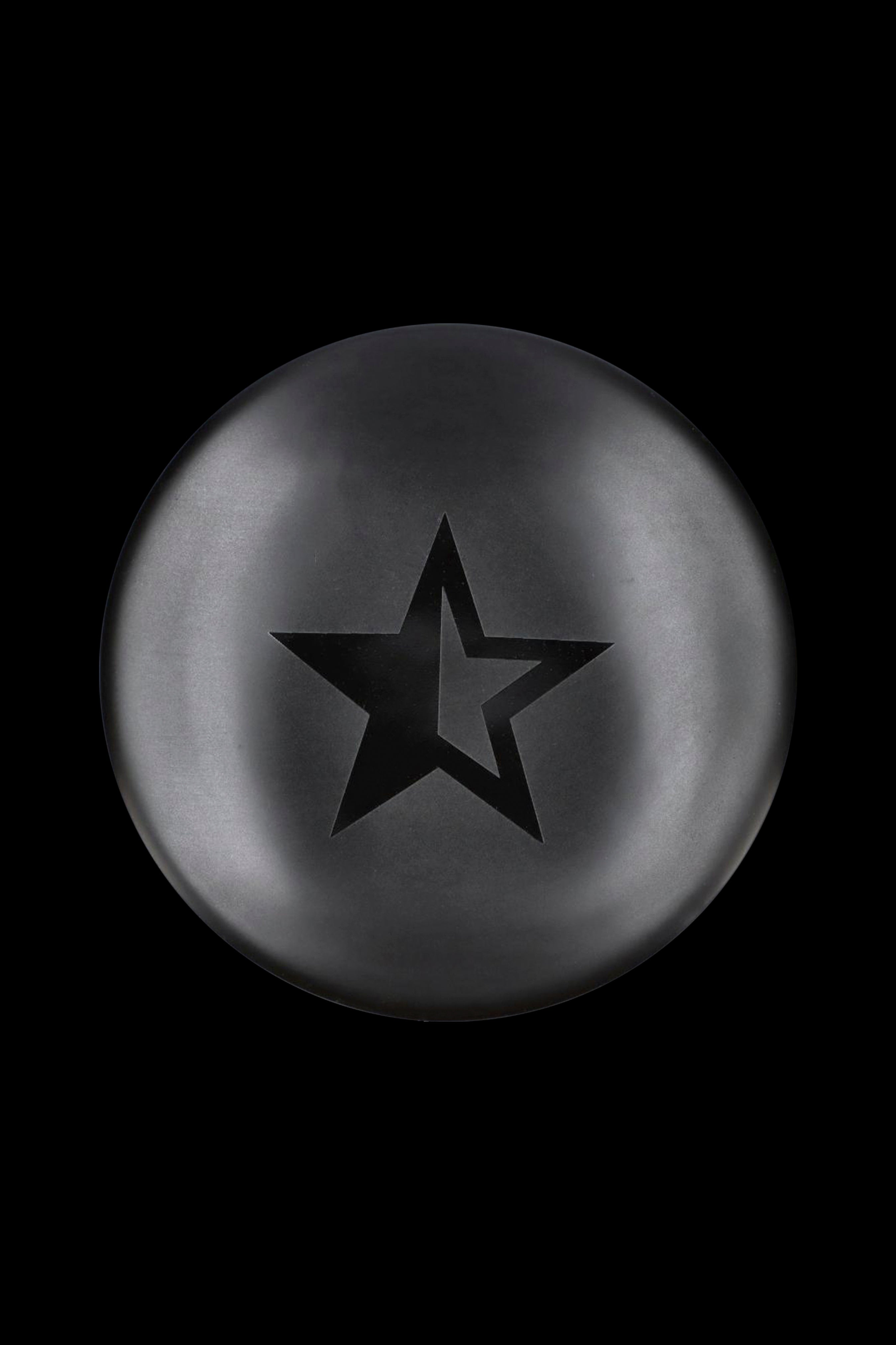 Black star-shaped silicone cap for cannabis concentrates.