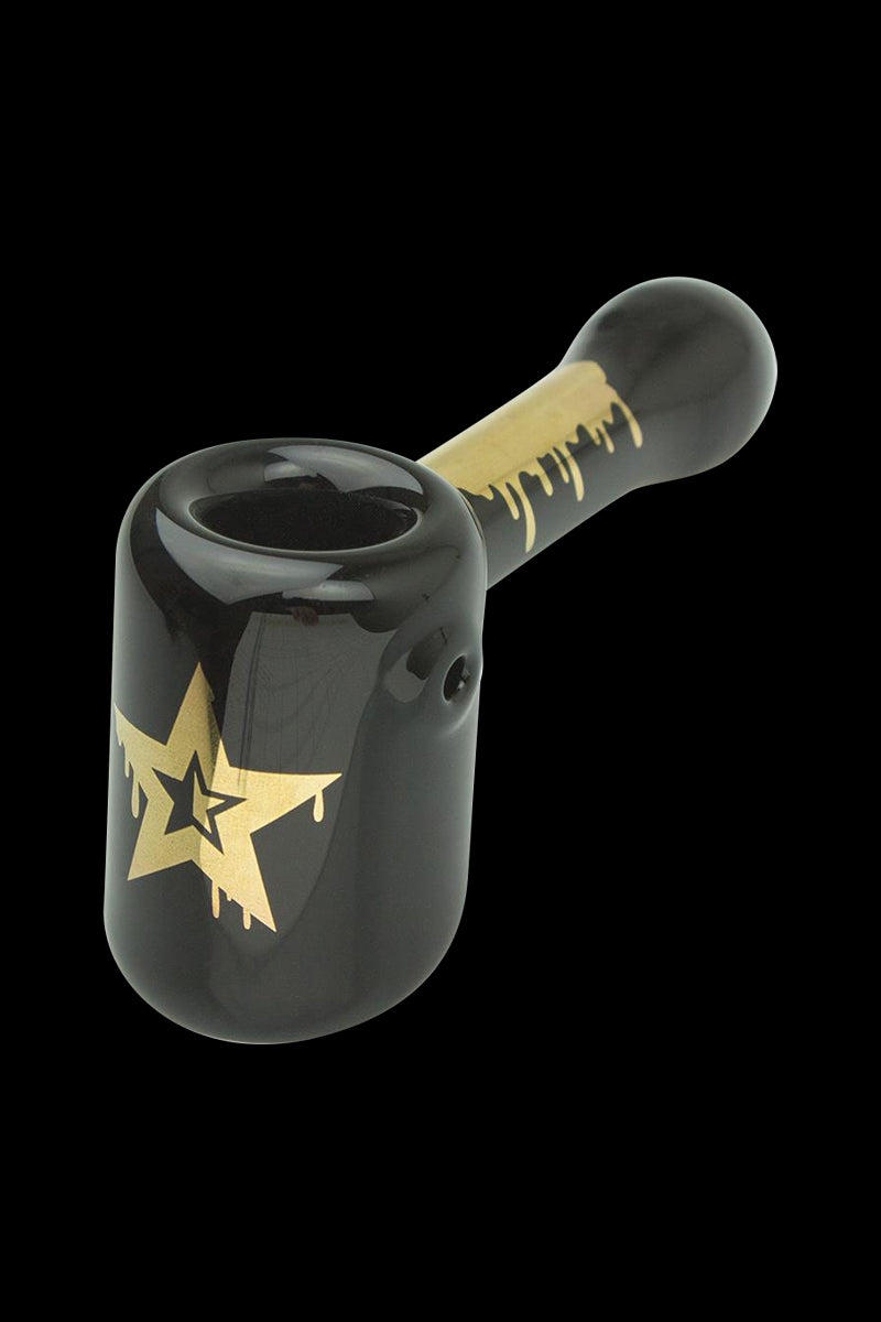 Front view of the Famous Brandz "Surrender" Hammer Hand Pipe, showcasing its dark, sculpted glass form against a plain black background.