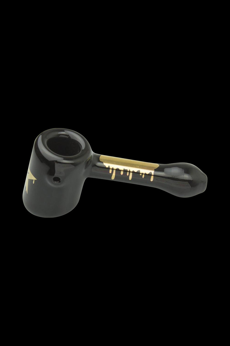 A side view of the Famous Brandz "Surrender" Hammer Hand Pipe, showing a dark-colored glass pipe with a unique hammer-style bowl.