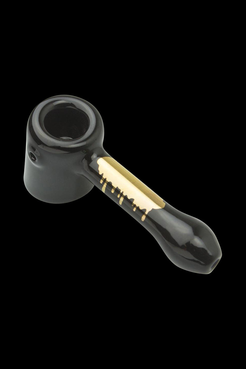 Front view of the Famous Brandz "Surrender" Hammer Hand Pipe, a darkly colored glass pipe with a unique curved design.