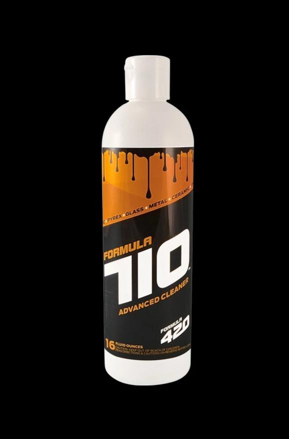 Centered front view of a white bottle labeled Formula 710 Advanced Glass/Metal/Ceramic Cleaner with orange drip graphics on a black background