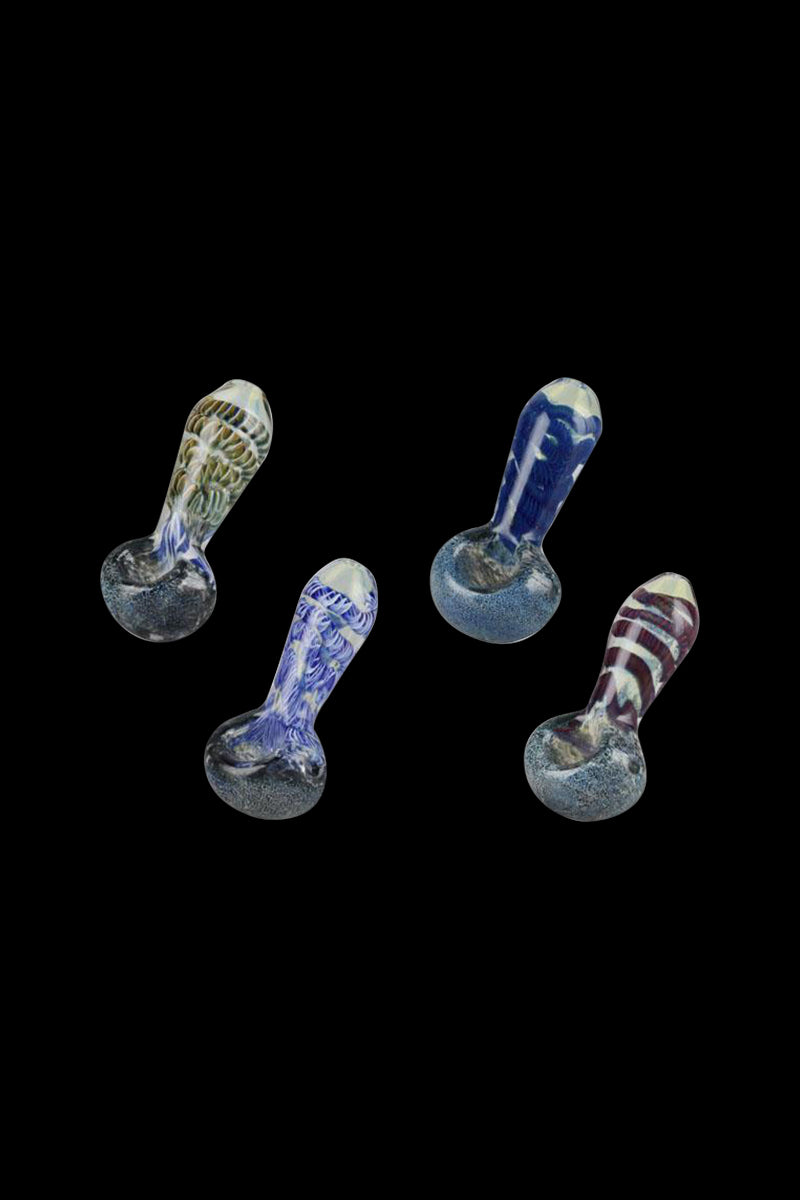 Top-down view of four colorful Smoke Cartel Frit & Cord Worked Spoon Hand Pipe pieces with patterned necks on a black background