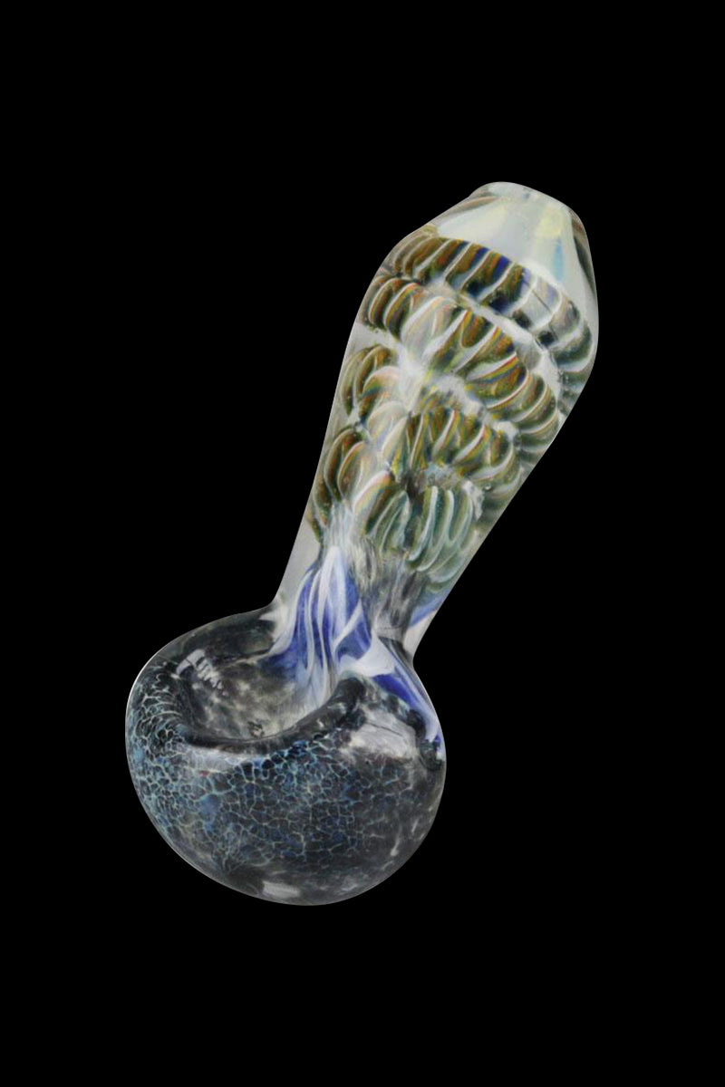 Angled view of a Smoke Cartel Frit & Cord Worked Spoon Hand Pipe showing a clear neck with greenish frit cord pattern and a dark crackled bowl against black background