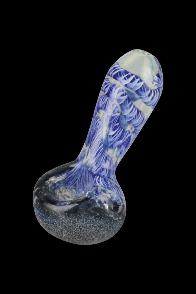 Angled close-up of a blue-and-white patterned Smoke Cartel Frit & Cord Worked Spoon Hand Pipe against a black background.