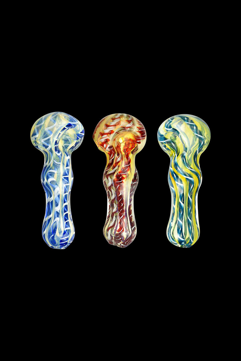 Three fumed latticino spoon pipe pieces are shown front-facing on black, the Fumed Latticino Spoon Pipe set displaying blue, red, and yellow swirling glass patterns.