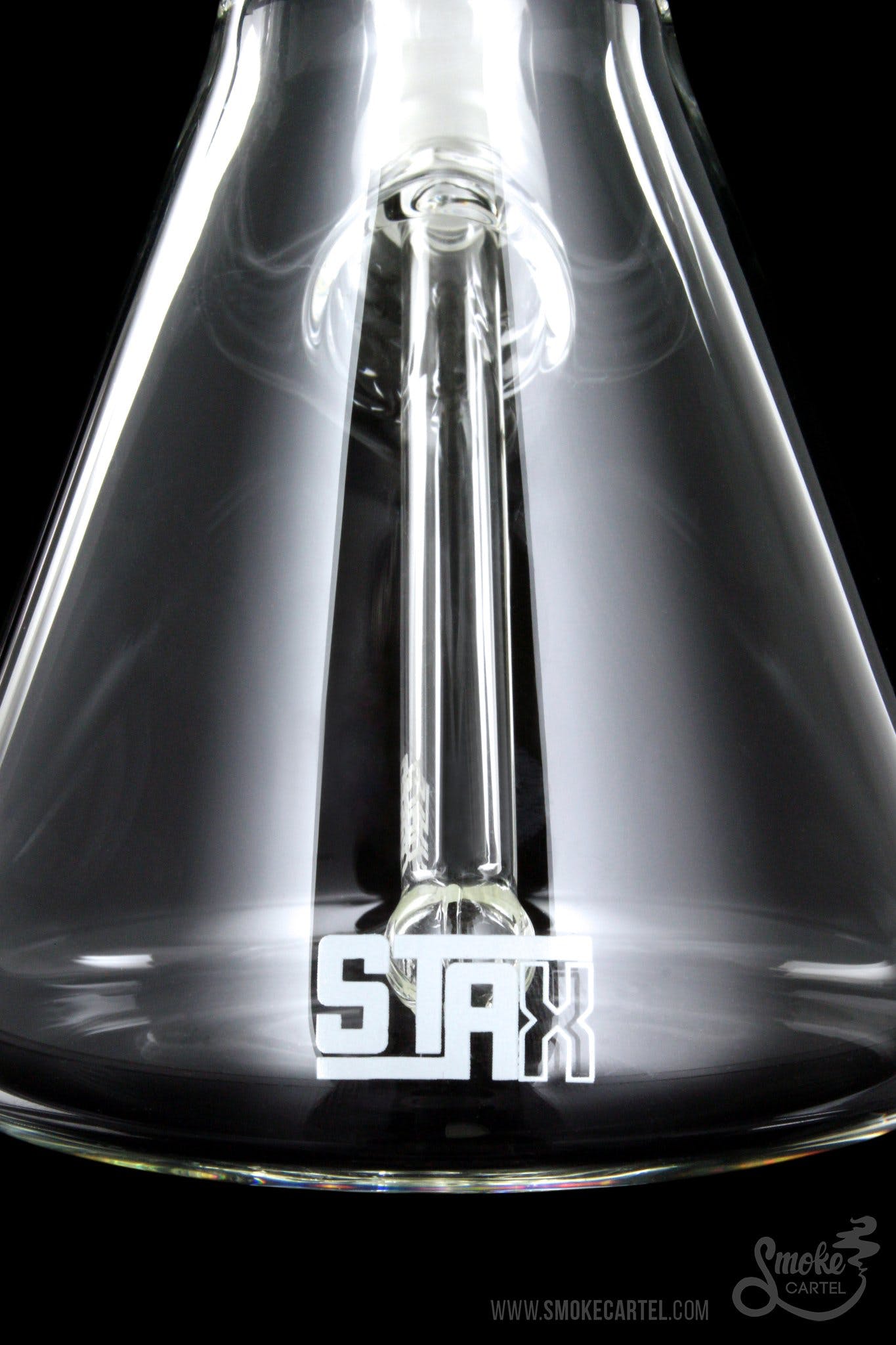A close-up, angled view of the GRAV® STAX Beaker Base, showcasing its clear glass construction and minimalist design.