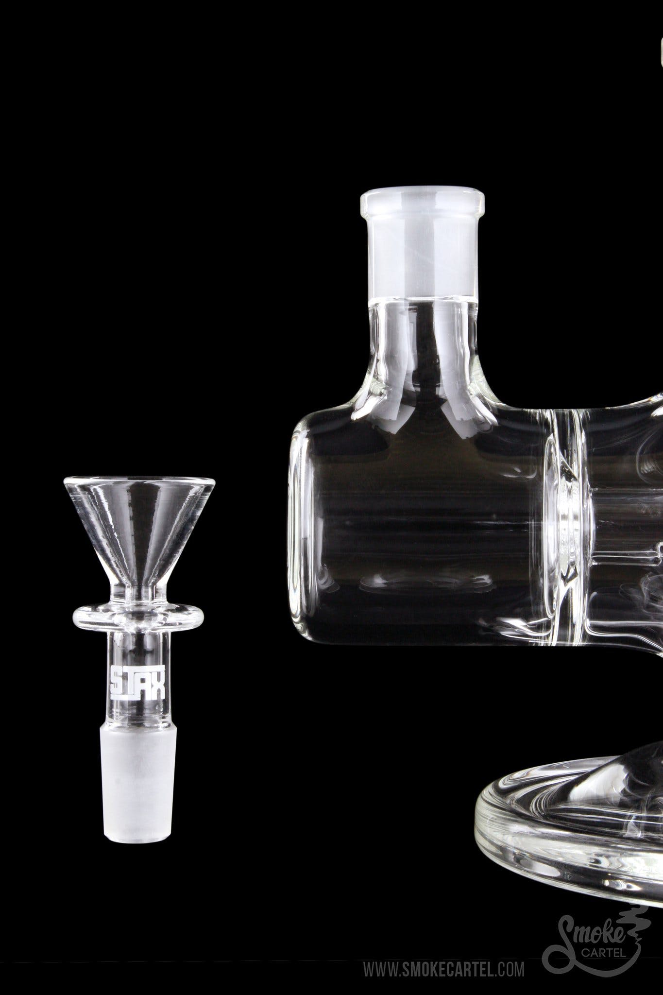 A close-up, angled view of the GRAV® STAX Dual Action Inline Base, displaying its clear glass construction and simple design.