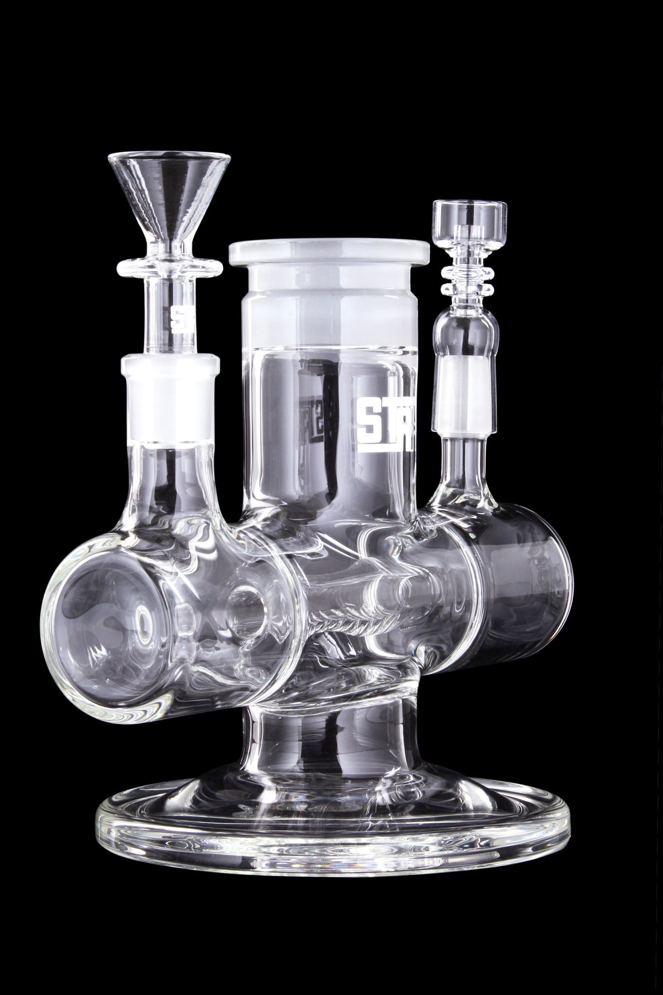 A studio shot displays the GRAV® STAX Dual Action Inline Base, showing the clear glass design from a slightly angled front view.