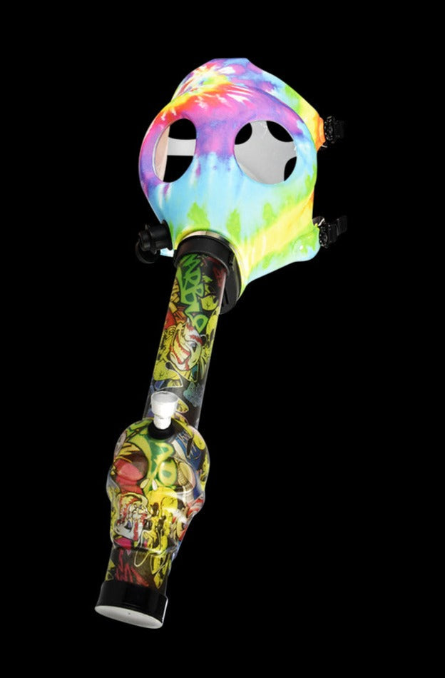 Angled view of a Gas Mask with Acrylic Bong showing a tie-dye gas mask top attached to a graffiti‑patterned acrylic bong on a black background.