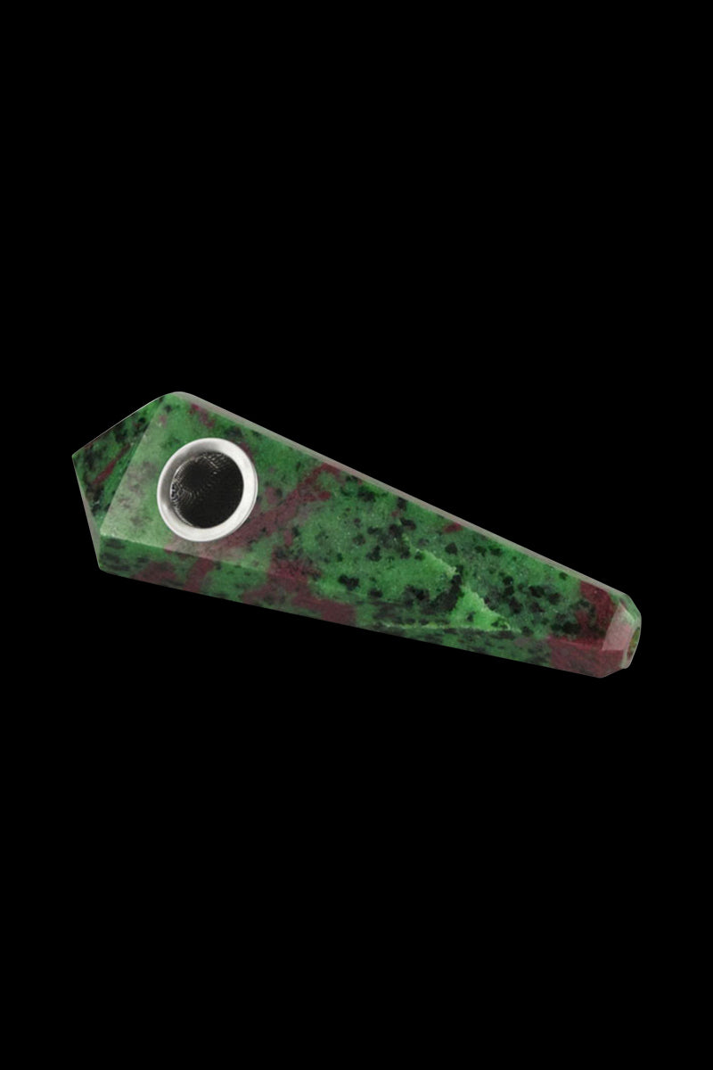Angled close-up of the Natural Gemstone Mineral Hand Pipe in opalite, showing its green and red mottled stone body and metal bowl against a black background.