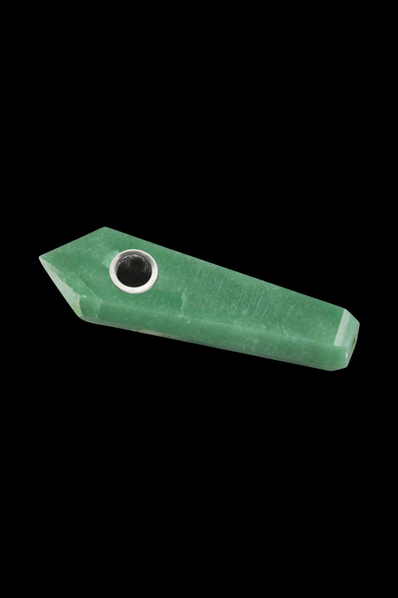 Angled close-up of a faux malachite Natural Gemstone Mineral Hand Pipe resting on a black background, showing its green faceted body and metal bowl.