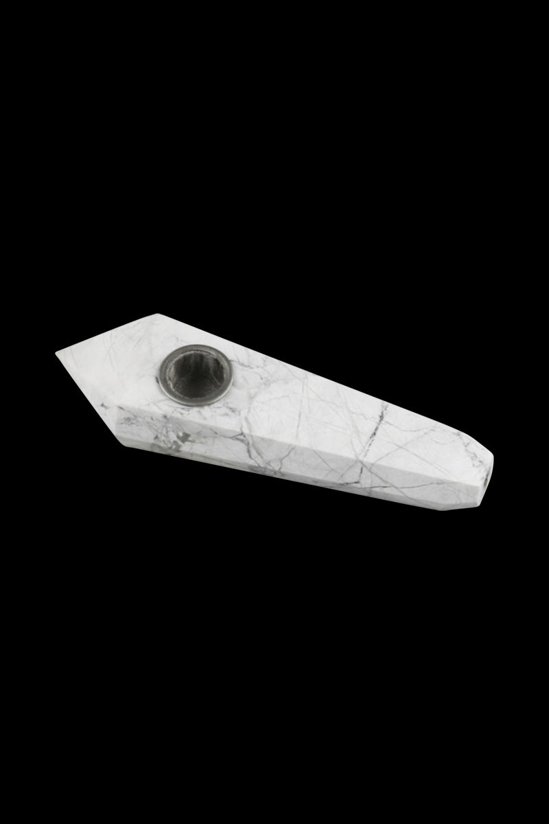 Angled top-down view of the Natural Gemstone Mineral Hand Pipe showing white marble-like veining and a metal bowl against a black background