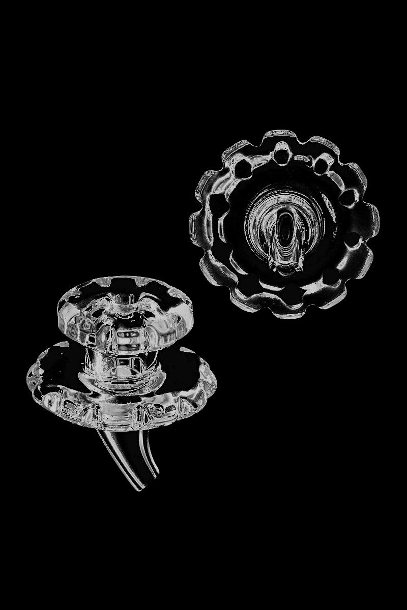 A close-up, angled view of the Glass Gear Carb Cap, showcasing its detailed, gear-like design in clear glass.