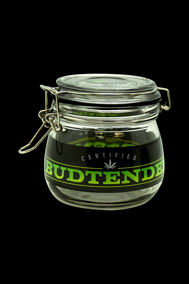 Front view of a large Dank Tank "Budtender" Airtight Glass Storage Jar on a black background, showing its metal clamp lid and green label.