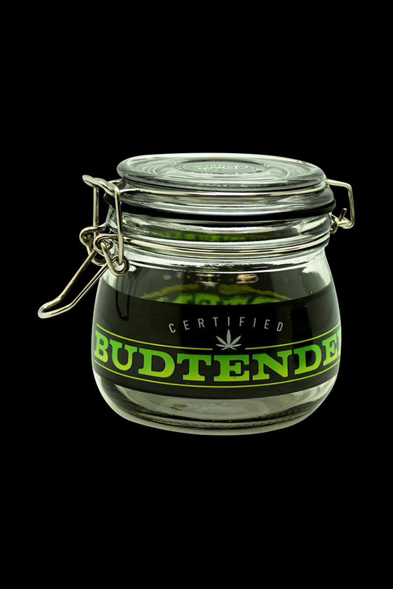 Centered front view of the Dank Tank "Budtender" Airtight Glass Storage Jar with its metal clasp lid and green "BUDTENDER" label against a black background