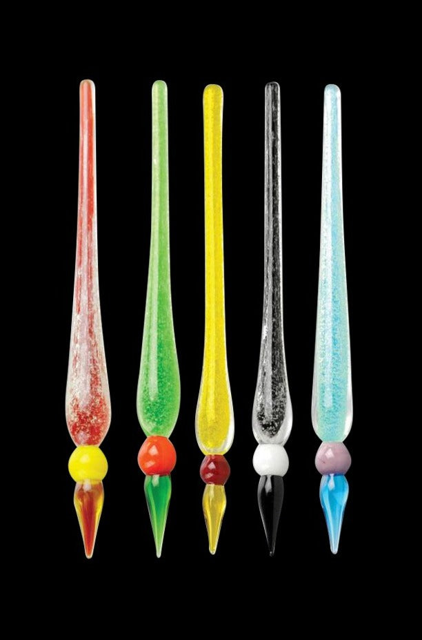 Row of five slender, glass Glow in the Dark Dabber Tool pieces in red, green, yellow, black, and blue shown upright against a black background