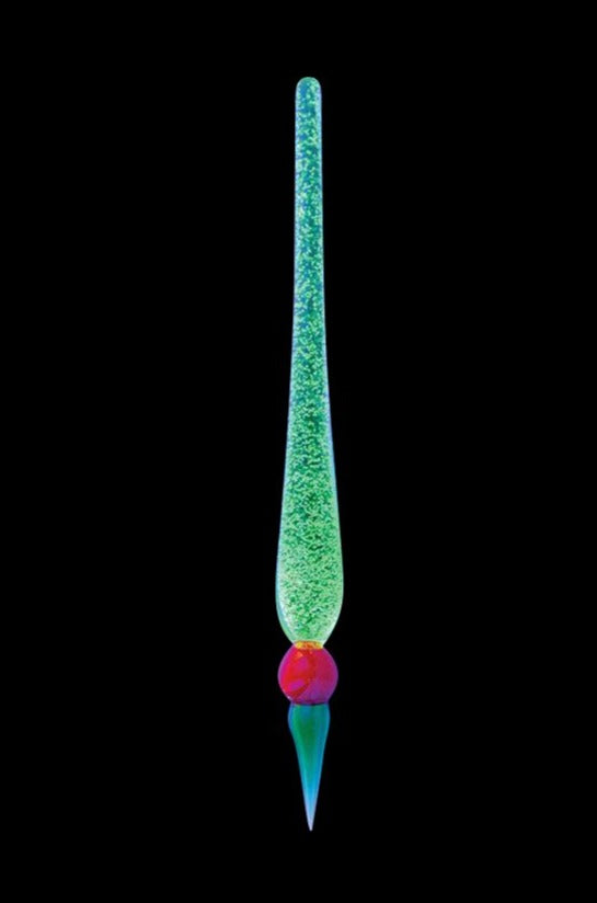 Center-aligned, glowing green and speckled Glow in the Dark Dabber Tool with a red orb near its tapered tip against a black background.