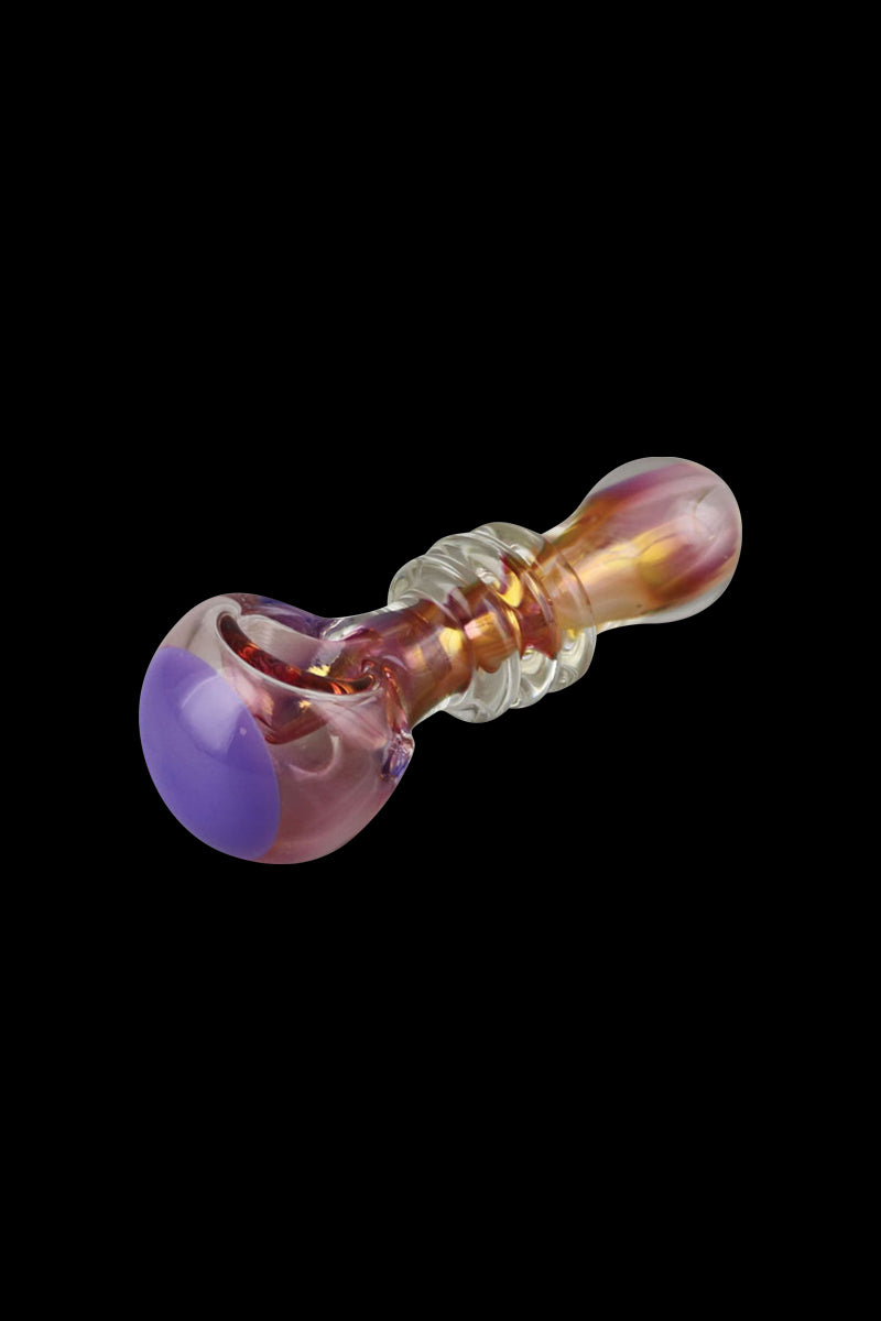 A close-up, angled view of the Gold Fumed Glass Spoon Pipe - Jetson, showcasing its curved bowl and iridescent glass finish.