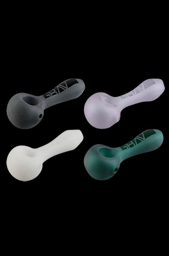A close-up shows the frosted glass GRAV® Frosted Spoon Pipe angled slightly from above, revealing its smooth, curved design.