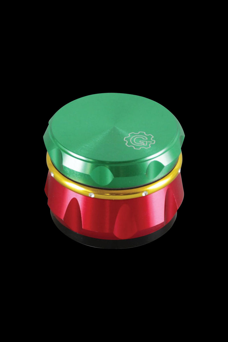 Top-down view of a red, gold, and green Pulsar Carver 4-Piece Grinder centered on a black background.