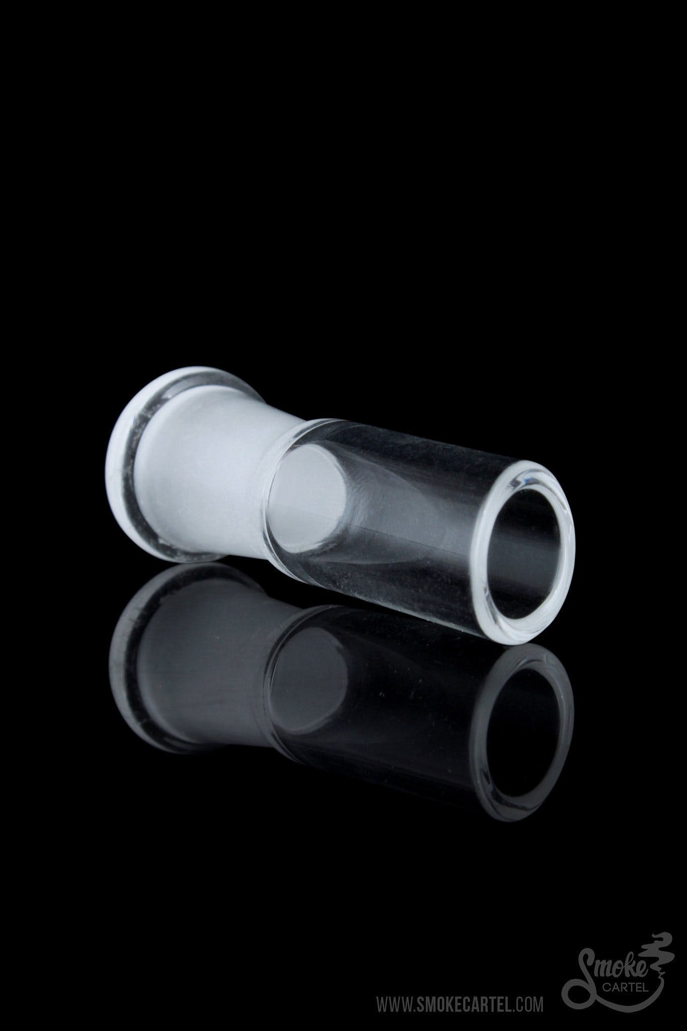 A studio shot displays the Angled Cut Vapor Dome, with its clear glass and unique angled design reflected on a dark surface.