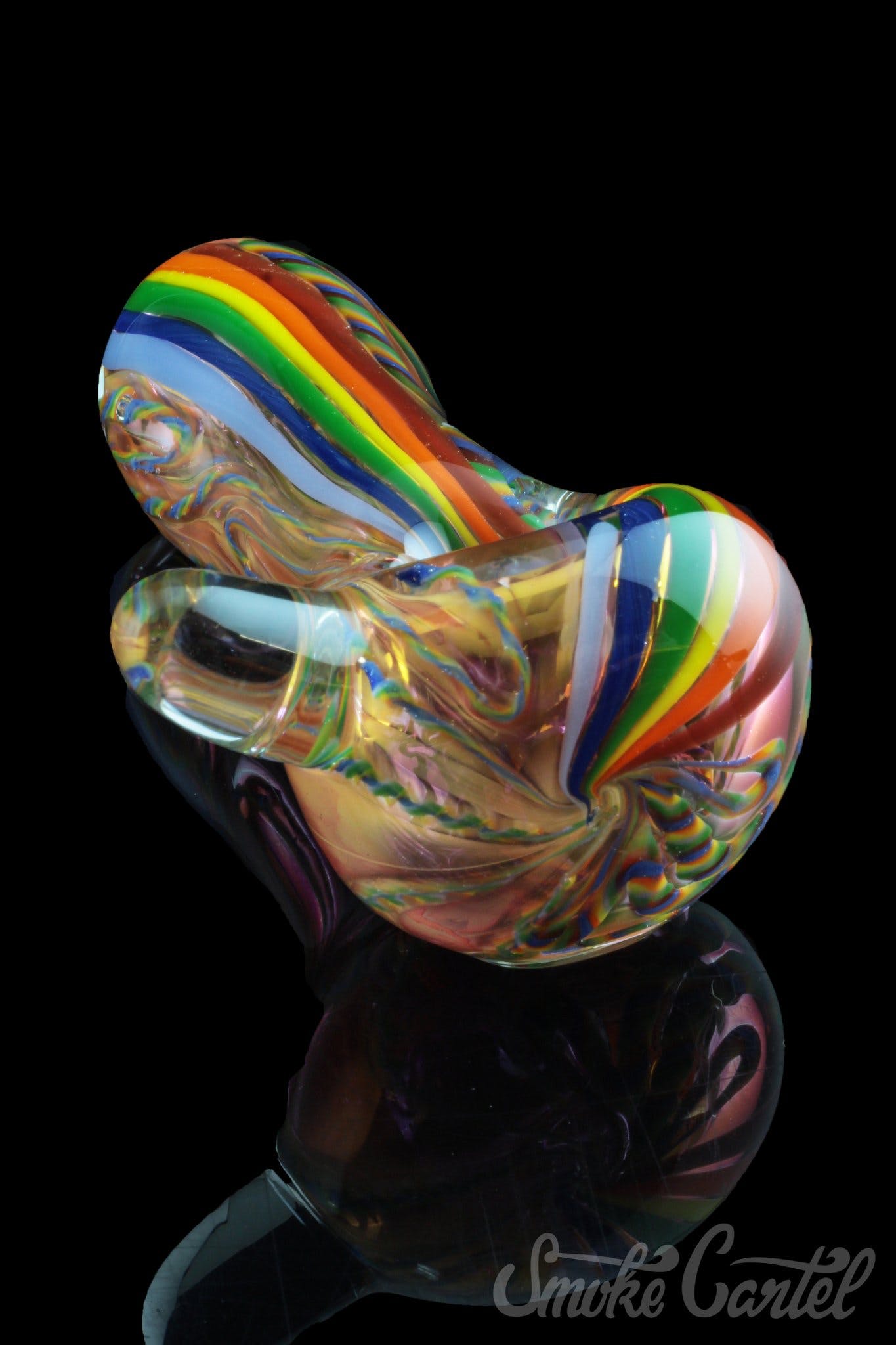 A vibrant, angled view of the Heavy Cane Worked Rainbow Spoon – Rainbow Mega Pipe, showcasing its colorful, sculpted glass design.