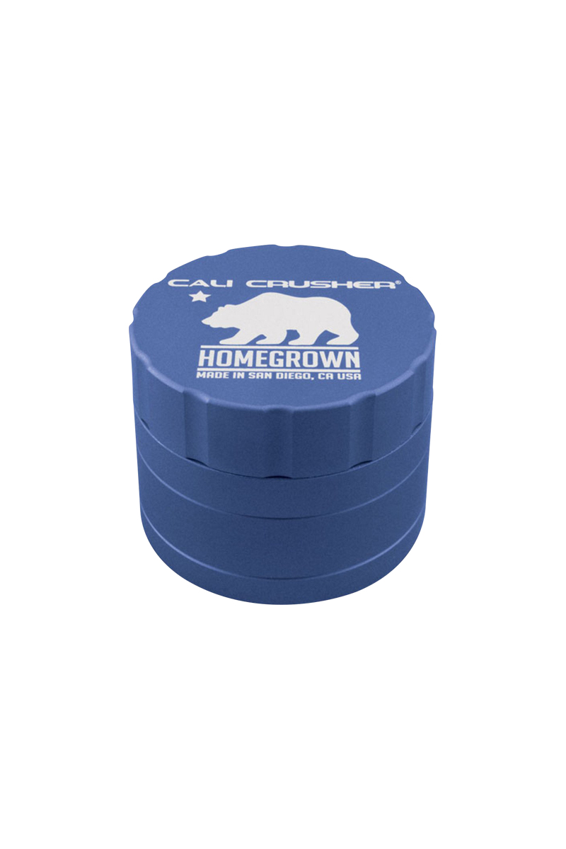 Top-down view of the blue Cali Crusher Homegrown 4 Piece Grinder with white bear logo and scalloped lid edge.